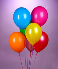 bright balloons on purole background