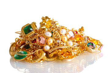 Various gold jewellery isolated on white