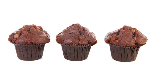 Three chocolate cupcakes over white background