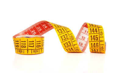 Yellow measure tape over white background
