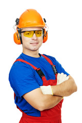 builder in hard hat, earmuffs and goggles