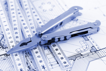 Fototapeta premium Pliers, metric folding ruler and architectural plan of the mode
