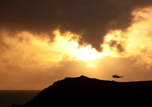 RAf Sea King flying into the sunset