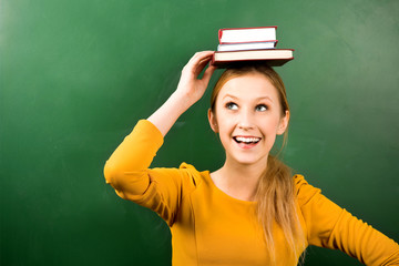 Female student balancing books on head