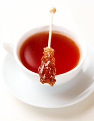 Cup of tea with sugar swizzle stick