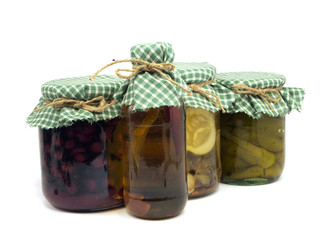 bottle of chilli oil, jar with preserved cherries, pickled cucum