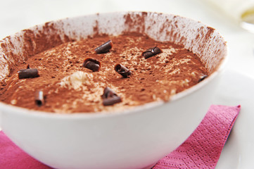 a bowl of tiramisu with a chocolate garnish