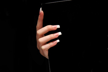 Human fingernail and beautiful manicure isolated on black