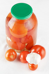 Glass jar with marinated tomatoes