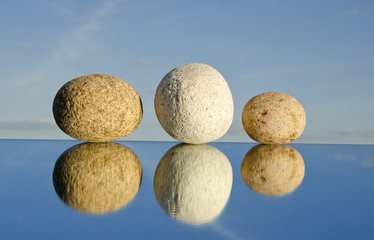 three natural stones on mirror