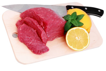 Cut of  beef steak, knife  with lemon slice. Isolated.