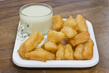 Deep fried dough sticks and a cup of soybean milk