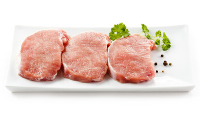 Fresh raw pork on white plate