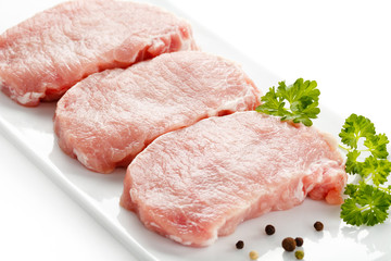 Fresh raw pork on white plate