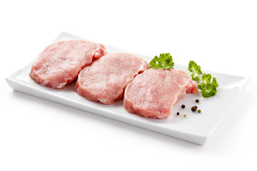 Fresh raw pork on white plate