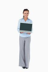 Businesswoman presenting laptop against a white background