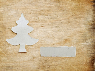 christmas tree made of torn paper on old wood background