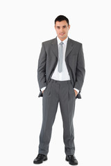 Businessman with his hands in his pockets against a white backgr