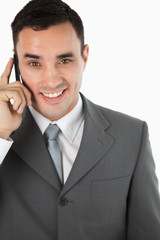 Close up of friendly smiling businessman on the phone