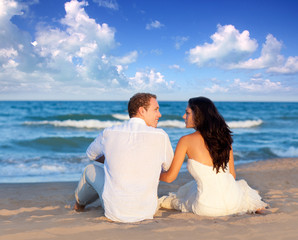 couple in love sitting in blue beach