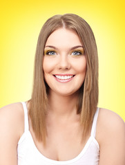 portraits of young happy blond girl on yellow background