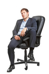 Young successful business man in executive chair