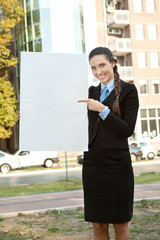 businesswoman pointing in  blank paper