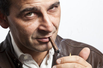 portrait of a cool mature man smoking a cigar