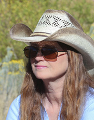 A Woman in a Cowboy Hat and Sunglasses
