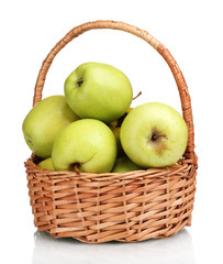 juicy green apples in the basket isolated on white