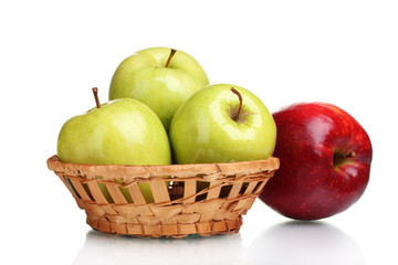 juicy green apples in basket and red apple isolated on white