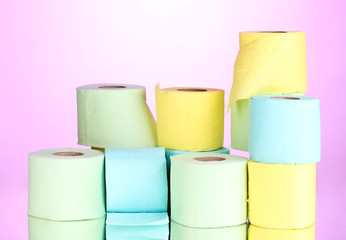 bright rolls of toilet paper on pink background