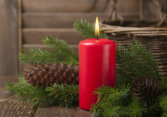 Christmas red candle and spruce branches