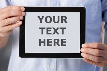 Man holding touchscreen computer for ad