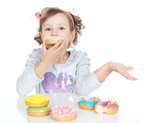 Little beautiful girl with donuts  over white