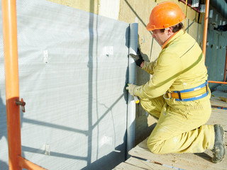 Facade Plasterer at exterior insulation work - obrazy, fototapety, plakaty