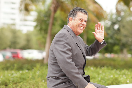 Businessman smiling and waving