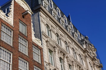 Typical Amsterdam houses over blue sky