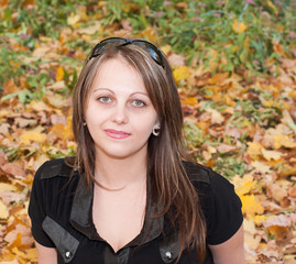 Beautiful brunette girl in autumn park