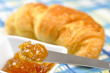 Orange jam and croissant