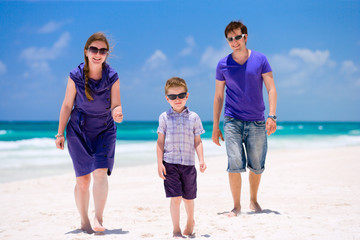 Young family walking along beach