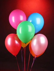 bright balloons on red background
