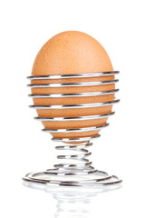 boiled egg in metal stand isolated on white