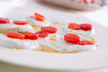 caprese salad in a outdoor restaurant table