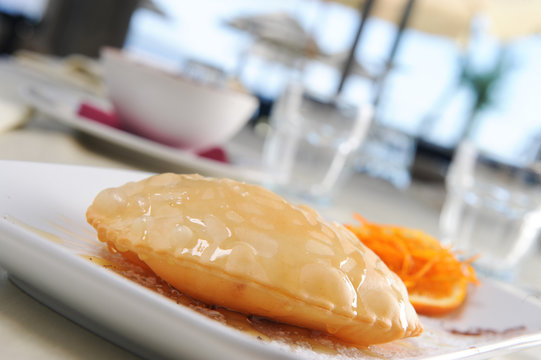 fried sebadas on a restaurant table