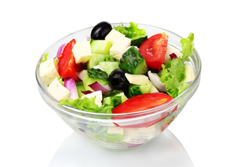 Tasty greek salad in transparent bowl isolated on white