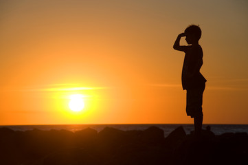 Young boy enjoying sunset