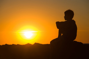 Young boy enjoying sunset