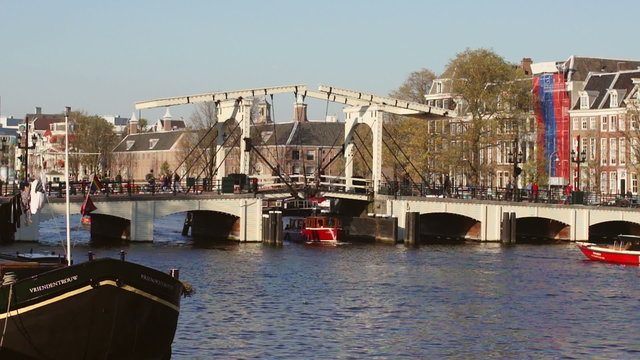Boats passing under a bridge in Amsterdam