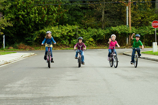 Group Of Kids Riding Bikes With Helmets On